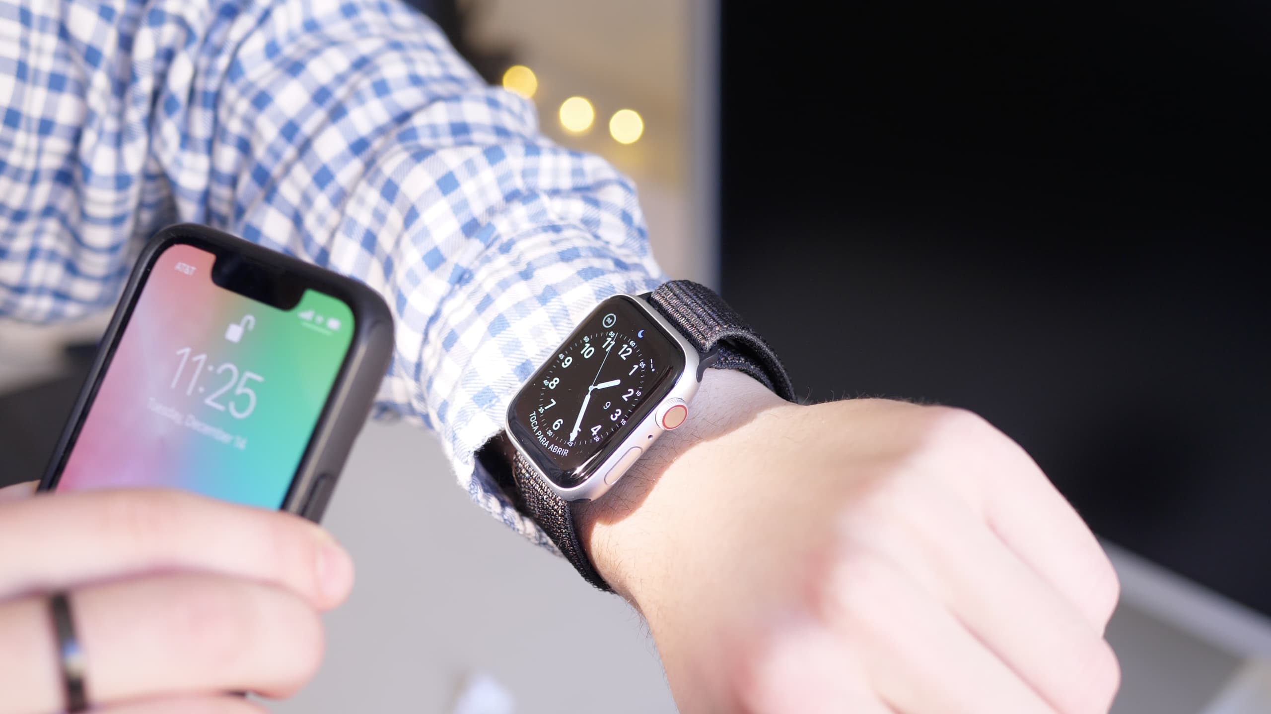 Shining bright light using iPhone flashlight on the dim Apple Watch screen to make it brighter