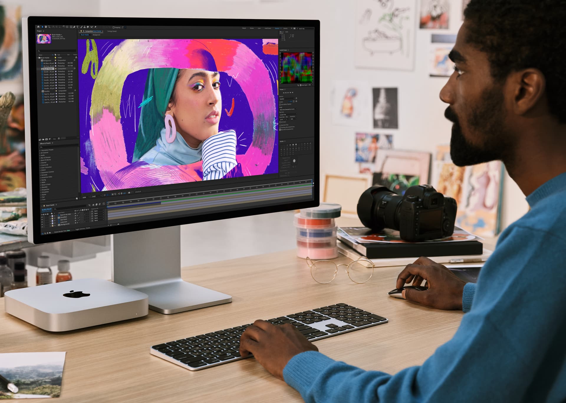 Lifestyle image showcasing a person using their M2 Mac mini and Studio Display setup to edit images 