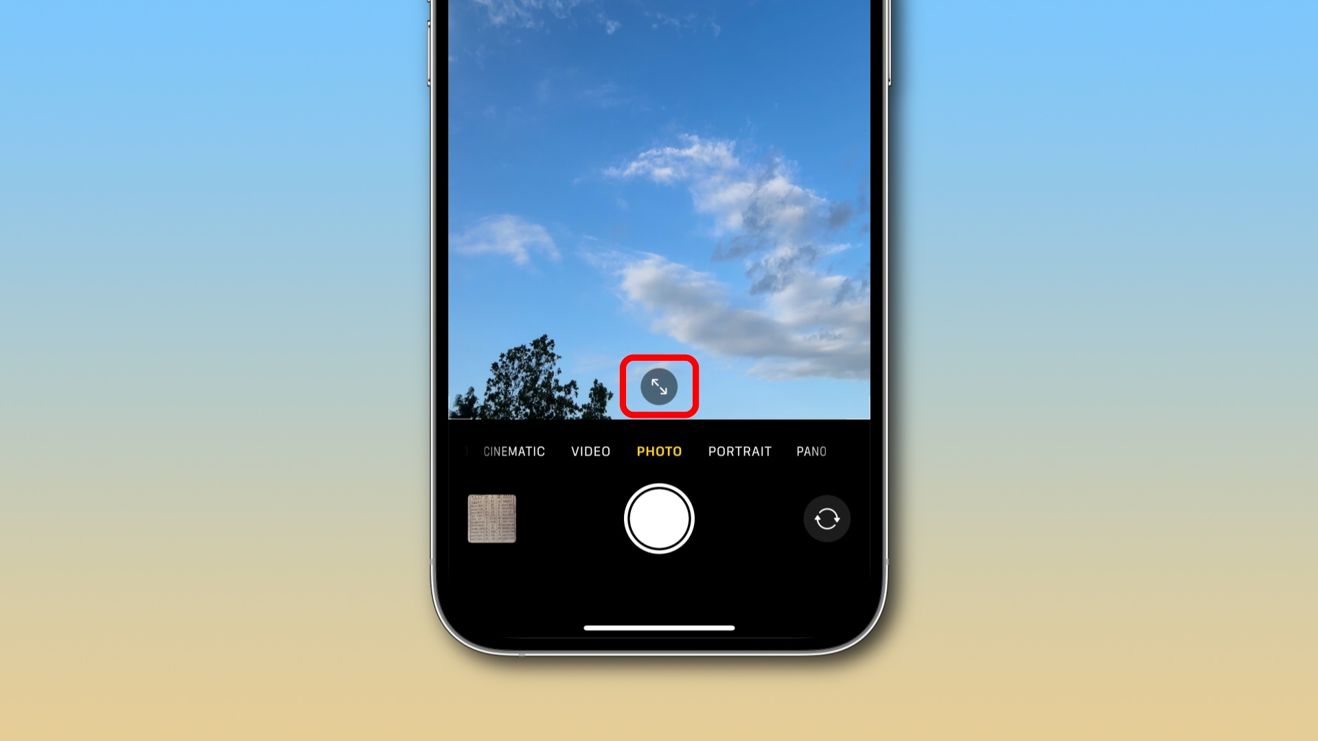 Apple's Camera app in selfie mode with a highlight around the resolution change arrow icon at the bottom