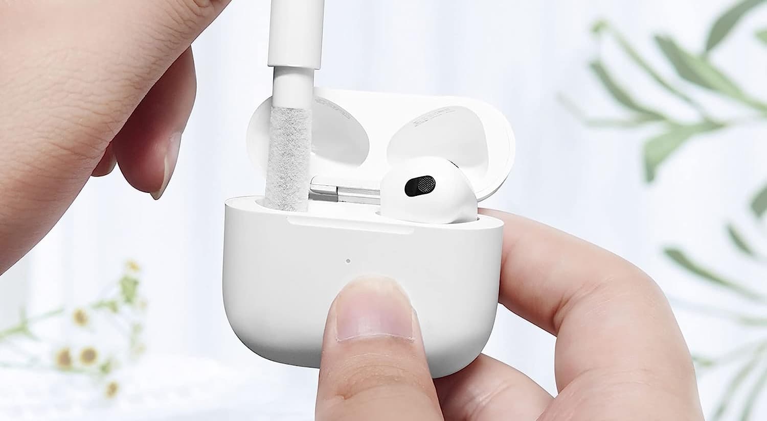 Cleaning AirPods Charging Case slot with a thin brush