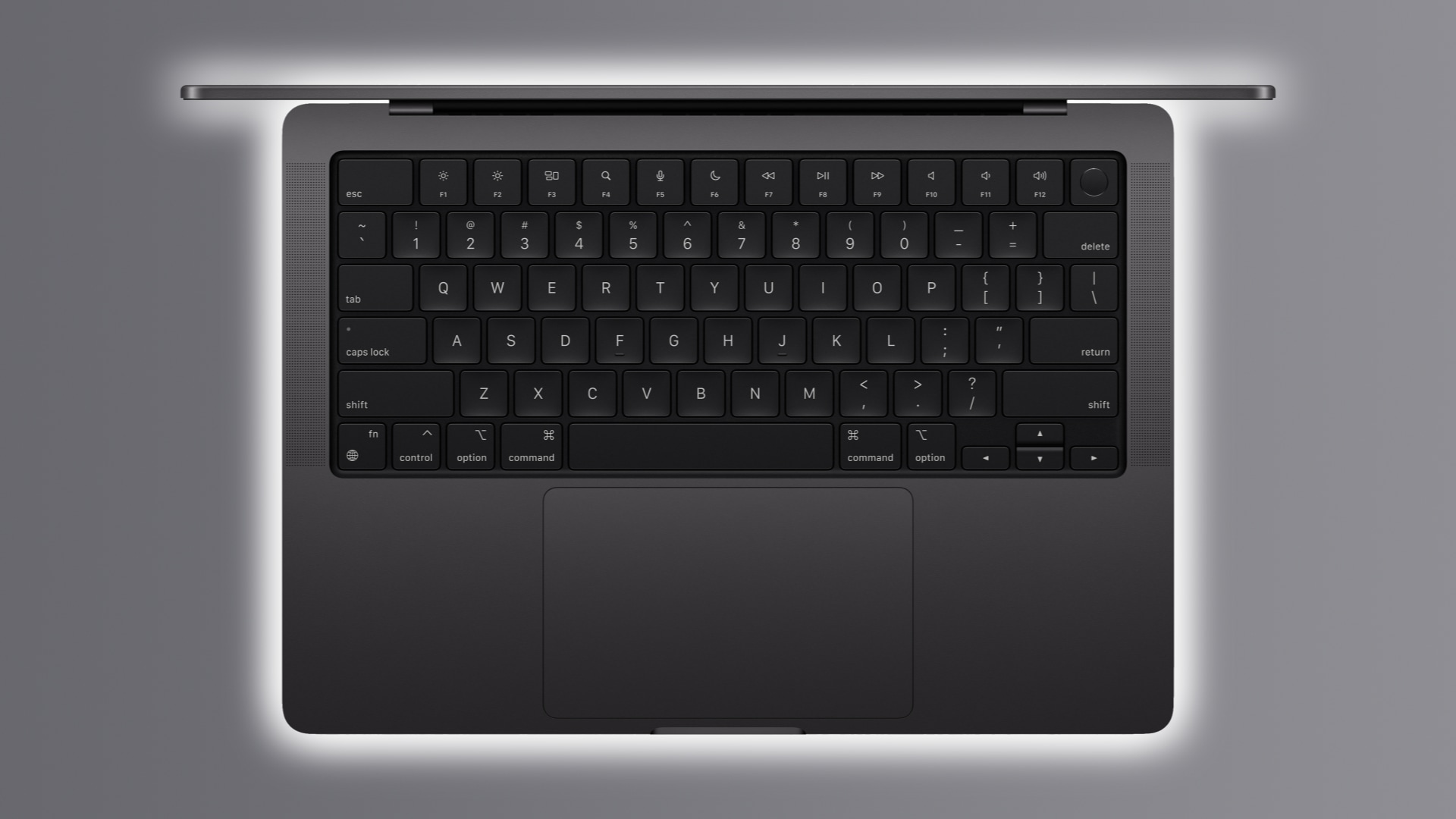 M3 MacBook Pro in Space Gray with its lid open, showcasing the backlit keyboard