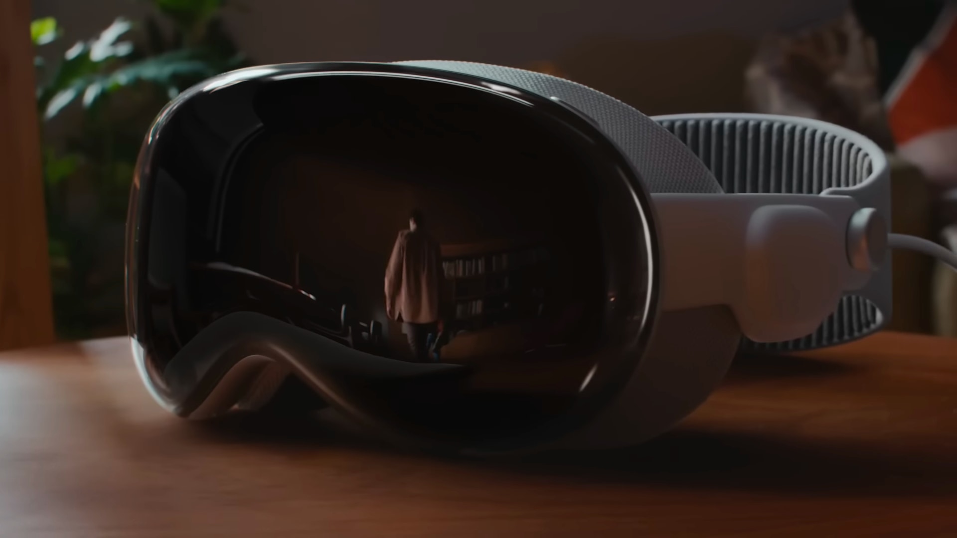 Closeup of the front of Apple's Vision Pro headset on a wooden table