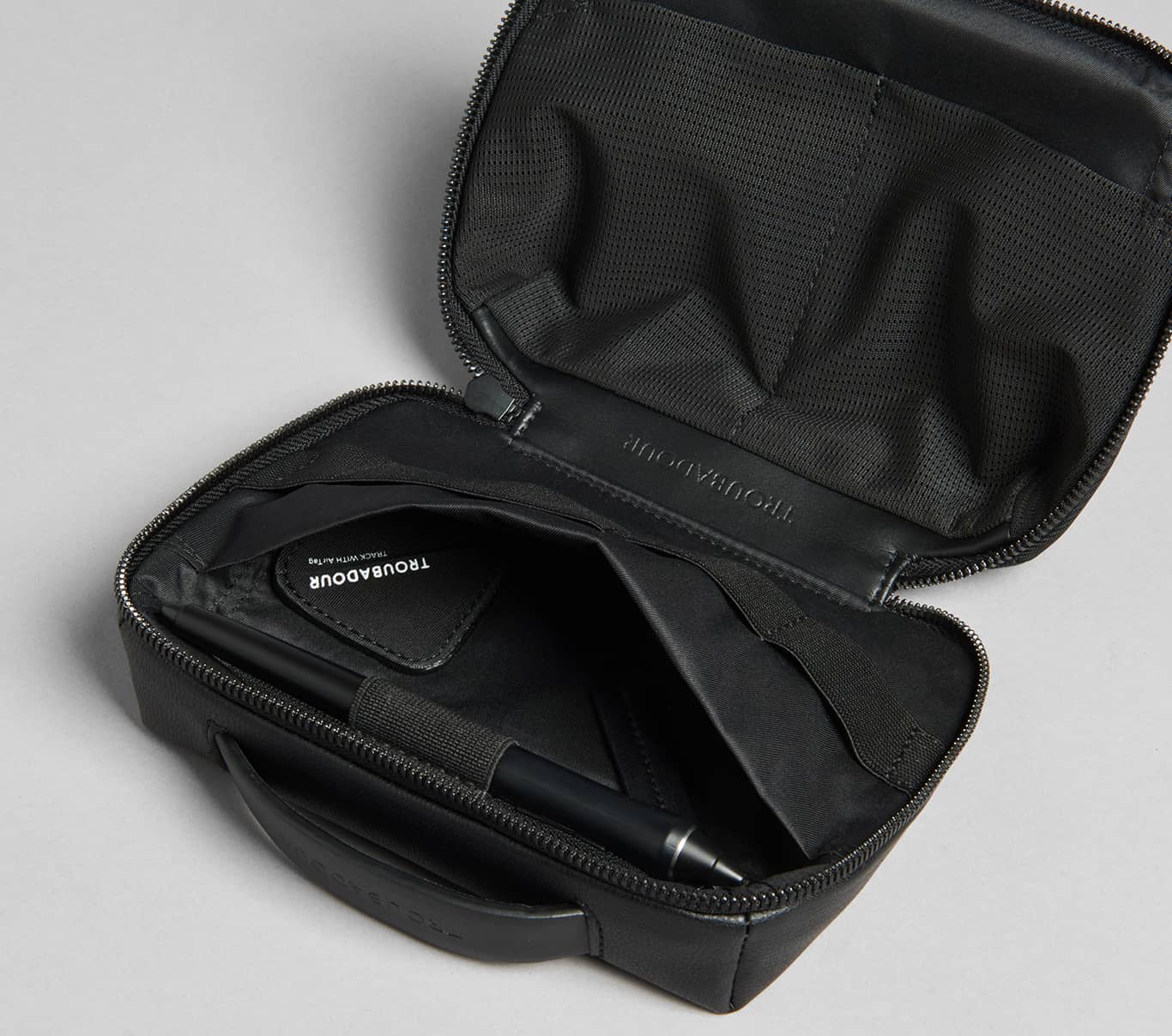 Troubadour's Buddy case showcasing its internal zipped pocket and pen storage