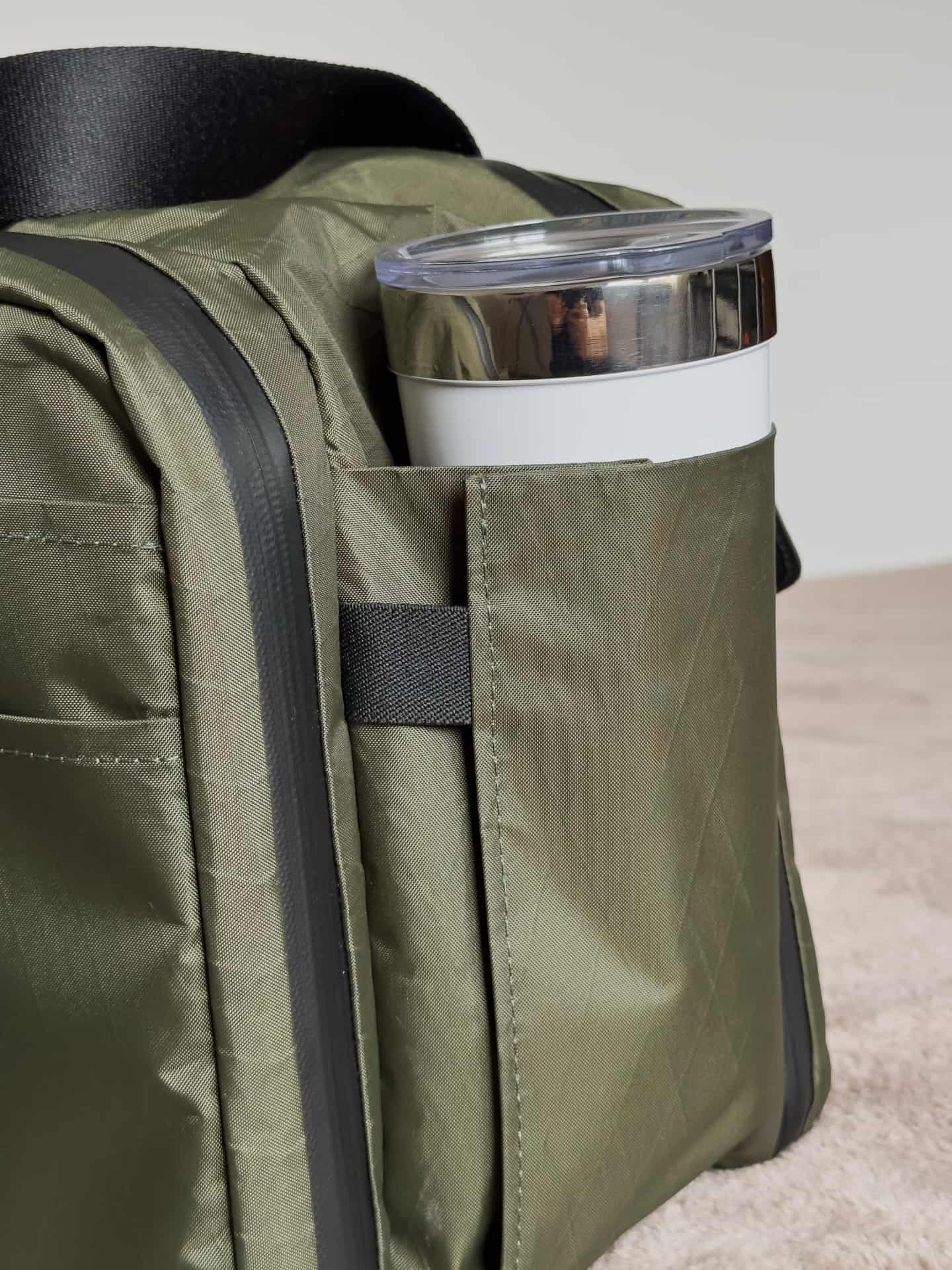 Closeup of the left side pocket with a water bottle on Waterfield's X-Air Duffel travel bag
