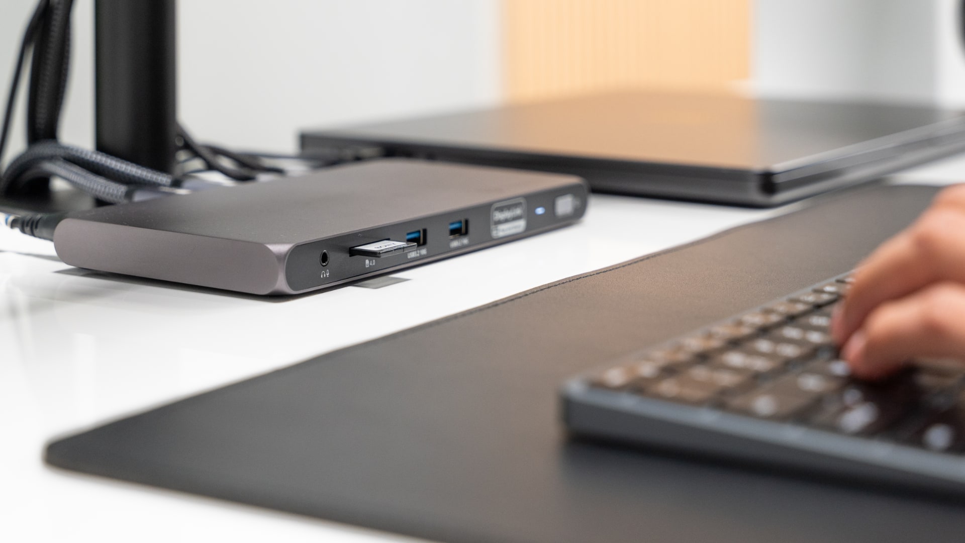 The rear ports on Satechi's Multi-Displays Thunderbolt Docking Station on a work desk, with an SD memory card inserted