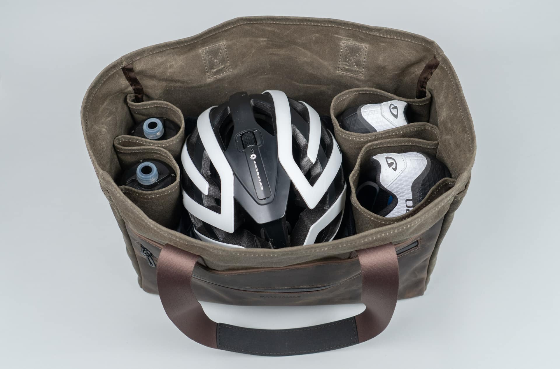 WaterField's leather cycling tote with a helmet, shoes and other items stowed in inside compartments