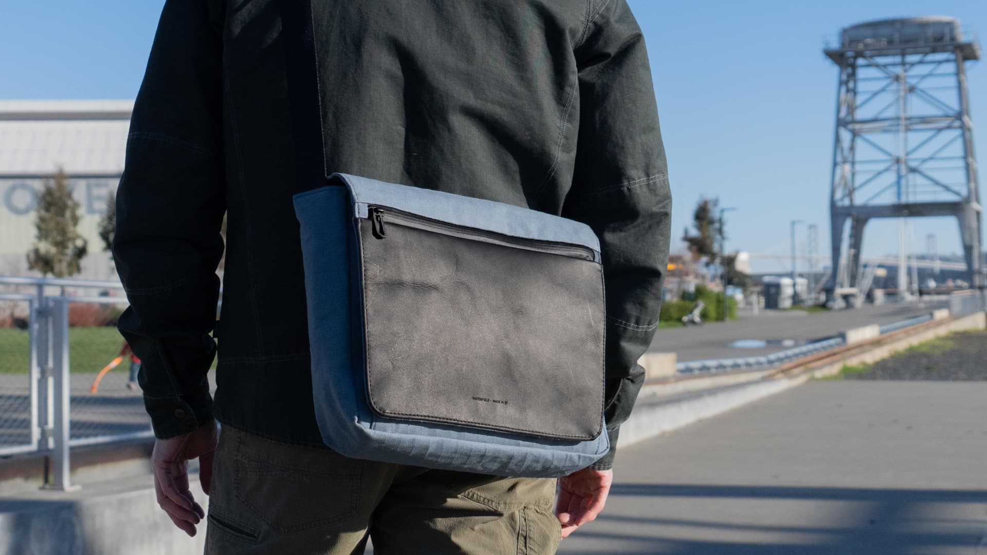 Man walking down the street with WaterField's Shinjuku messenger bag on his back