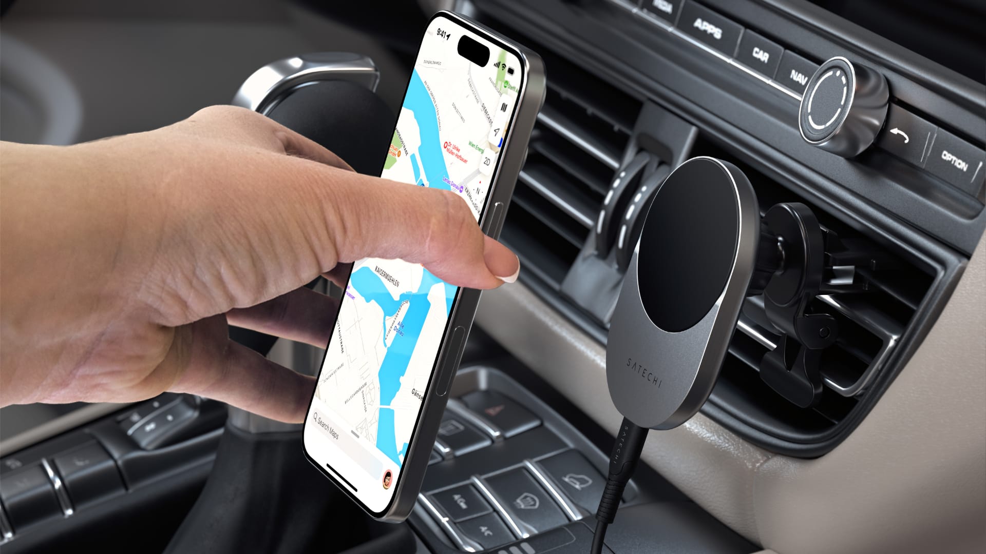 Female hand snapping an iPhone onto Satechi's Qi2 wireless car charger mounted on a vehicle's vents