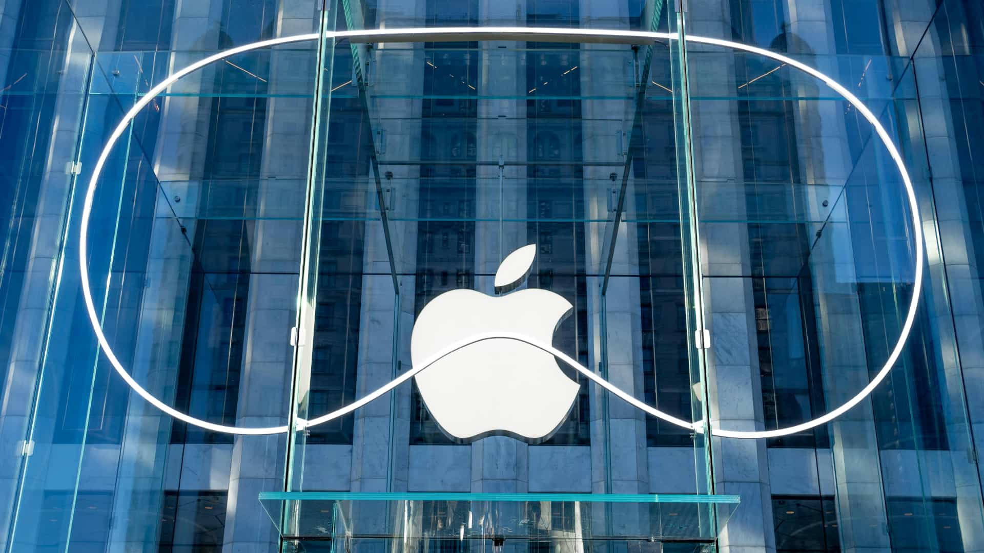 Vision Pro logo in front of the iconic Apple Store glass cube store on Fifth Avenue in New York.
