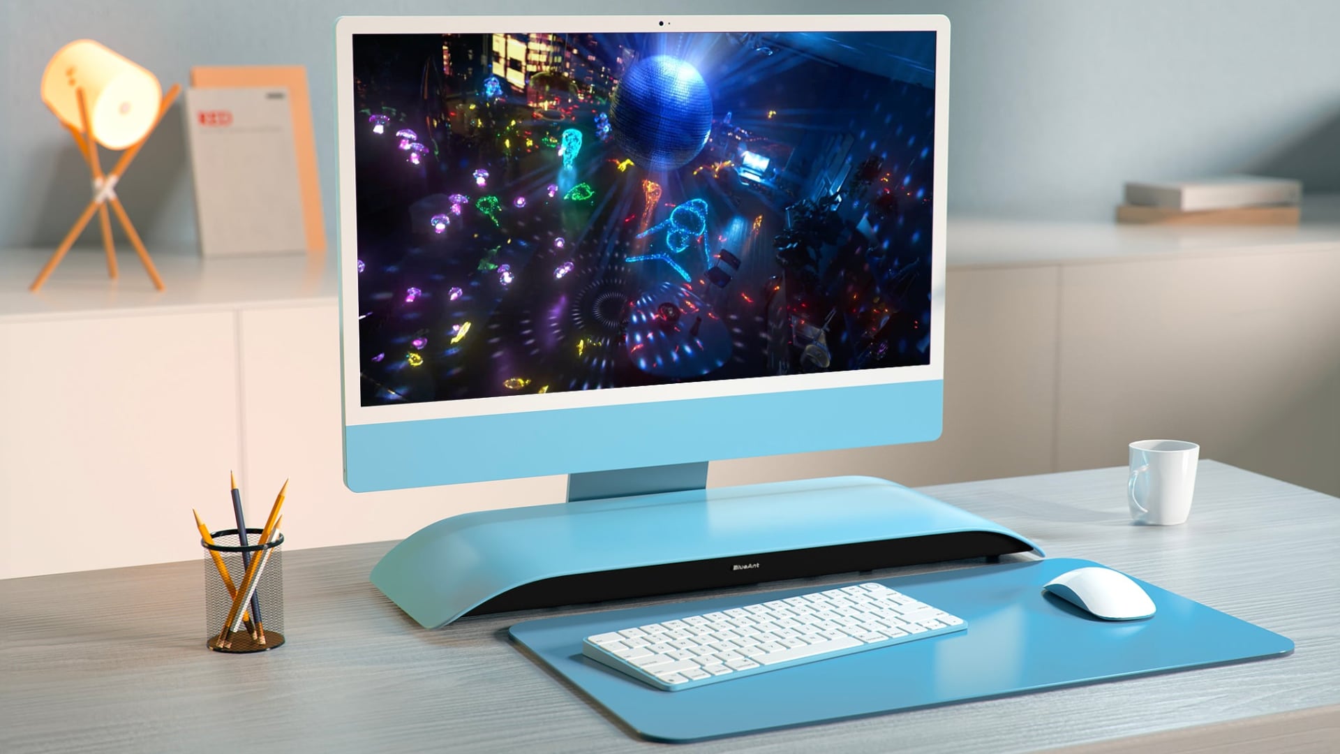 A modern work desk with a blue iMac and a color-matched Soundblade soundbar beneath it.