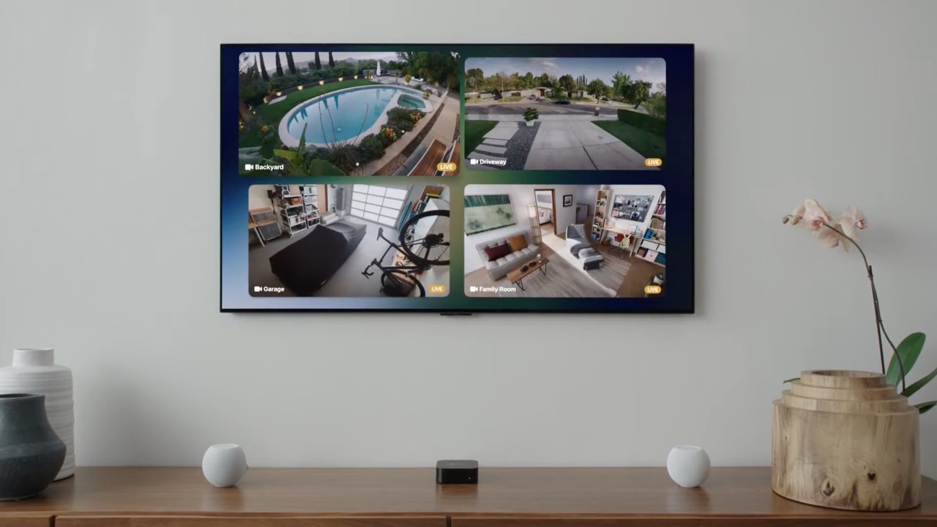 An image showing four simultaneous video feeds from HomeKit security cameras displayed in a 2x2 grid on Apple TV with tvOS 15