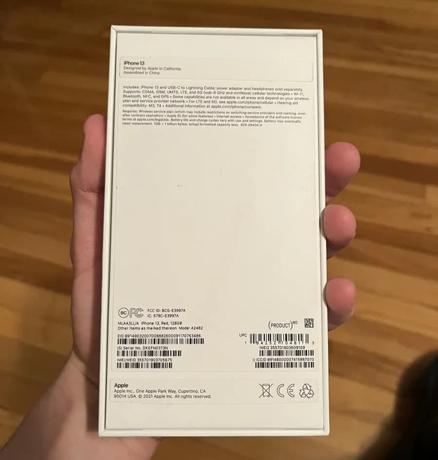 Holding iPhone box showing IMEI number