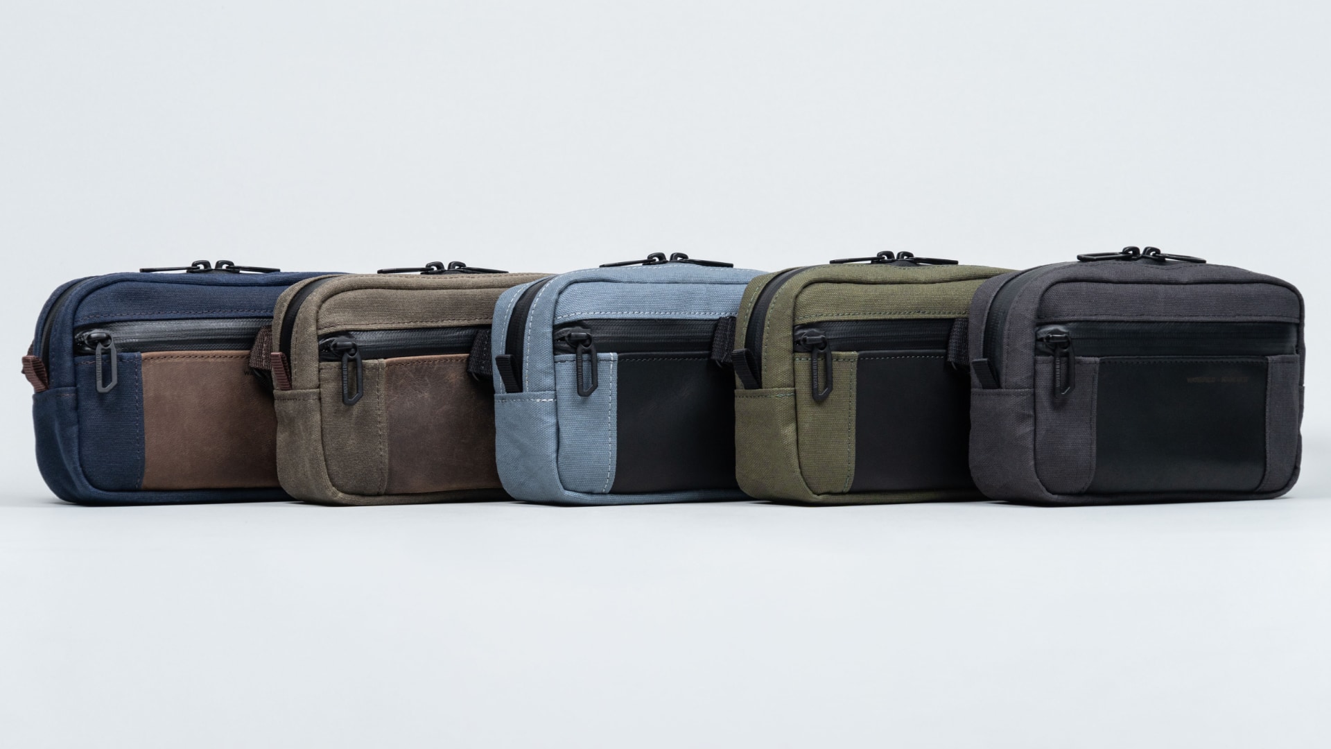 Six WaterField Shinjuku Sling tech cases showcasing color finishes.