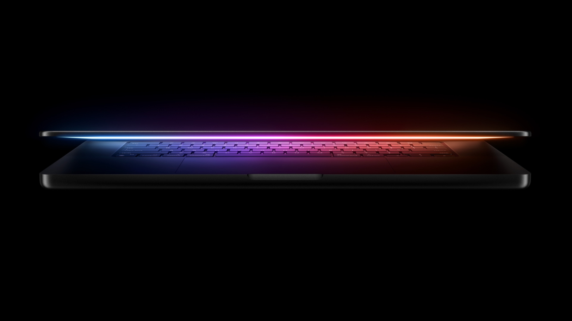 MacBook Pro laptop with its lid half-open, revealing a glowing display