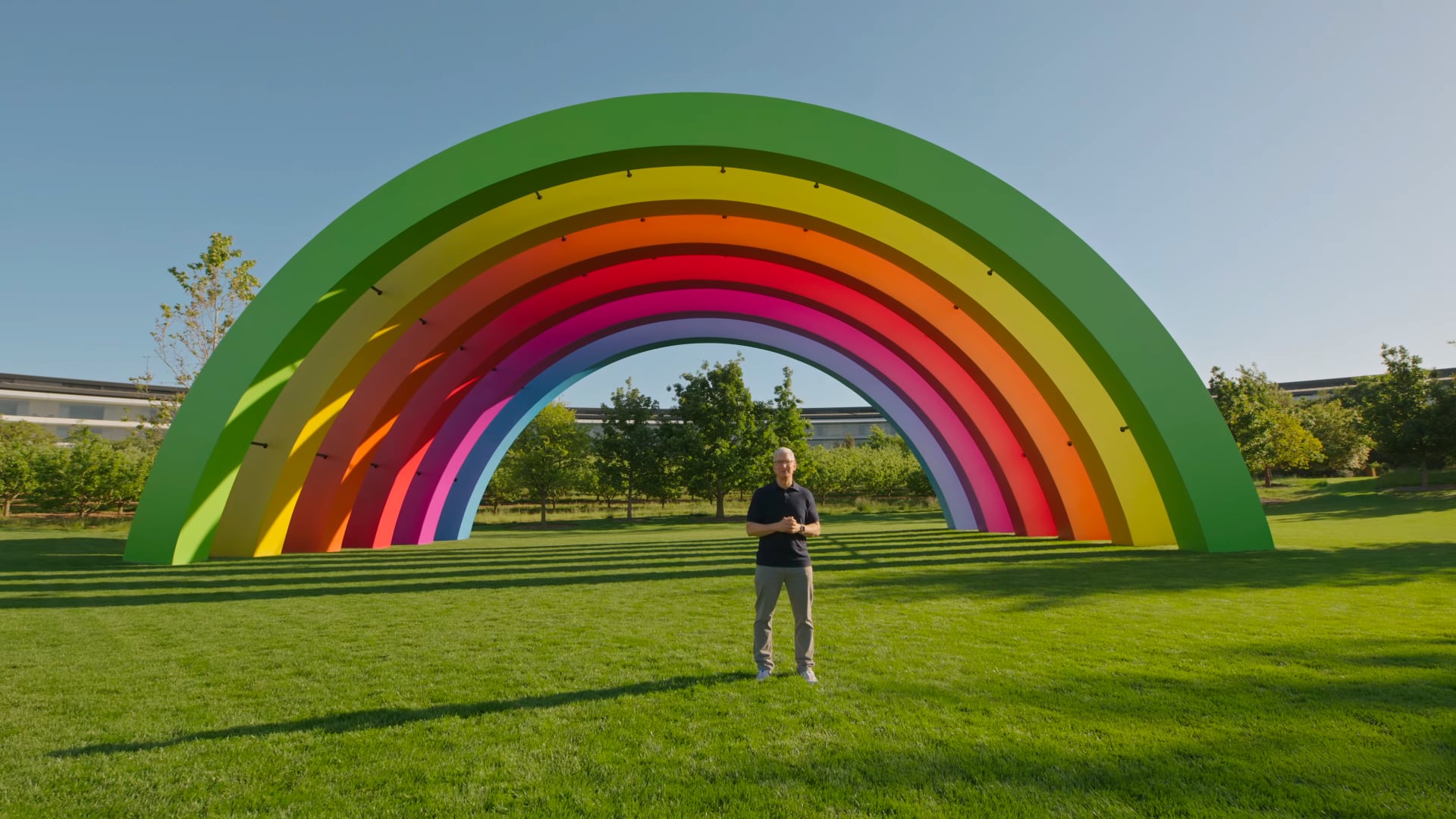 Tim Cook standing in front of the Apple Park's rainbow Stage