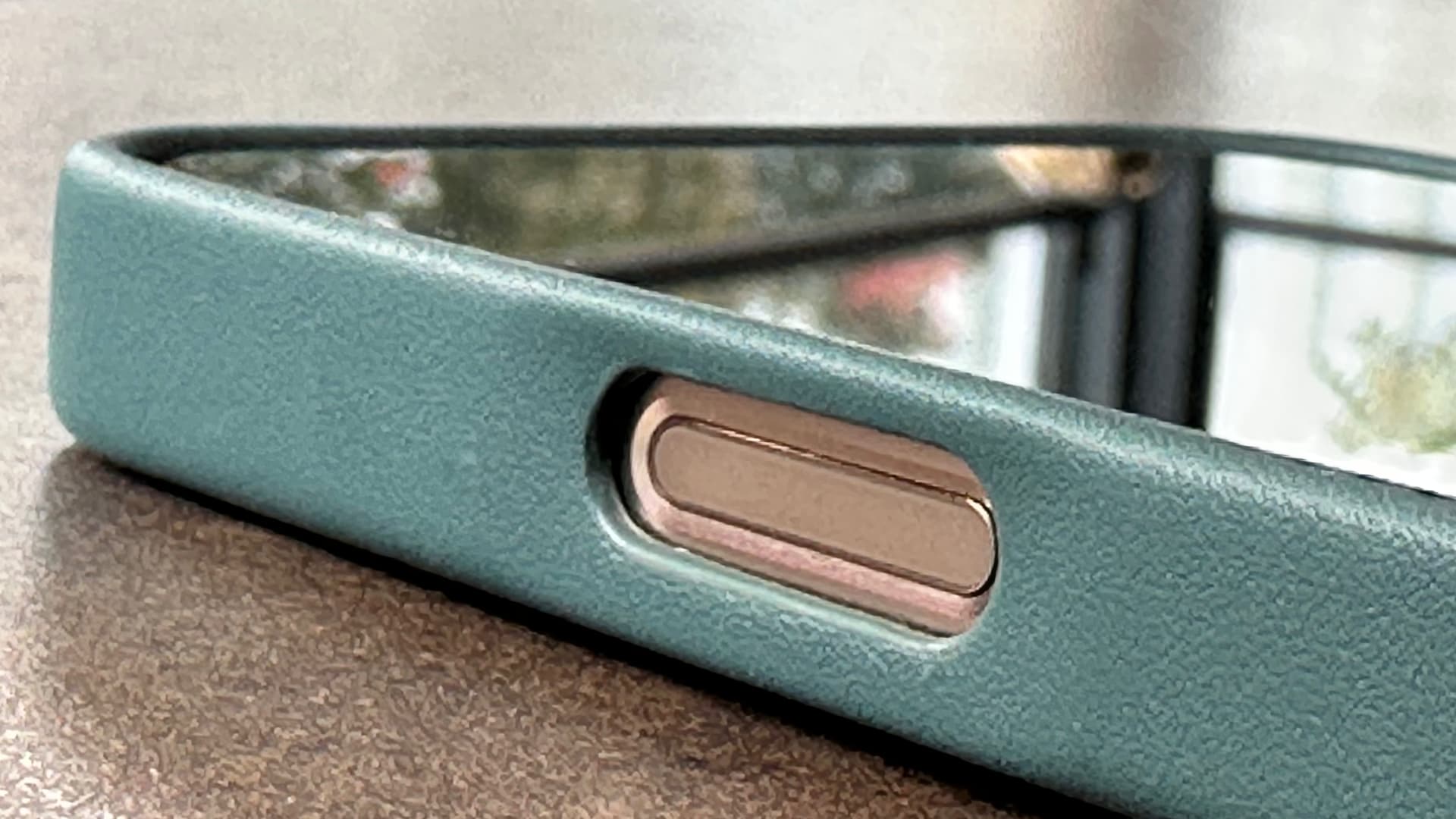 Closeup of the Camera Control button of an iPhone 16 Pro Max in Mujjo's full leather case.