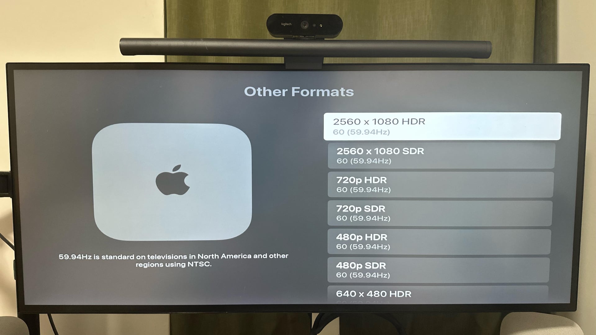 Stretched Apple TV interface on a 21:9 monitor.