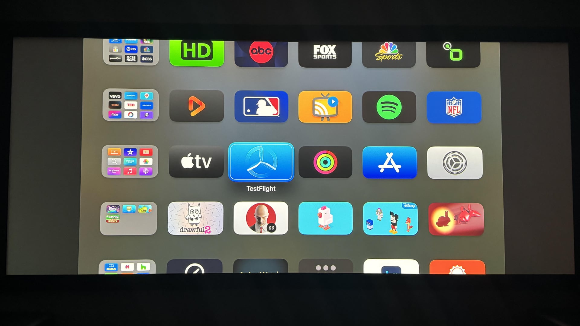 Stretched Apple TV interface with gray bars on sides.