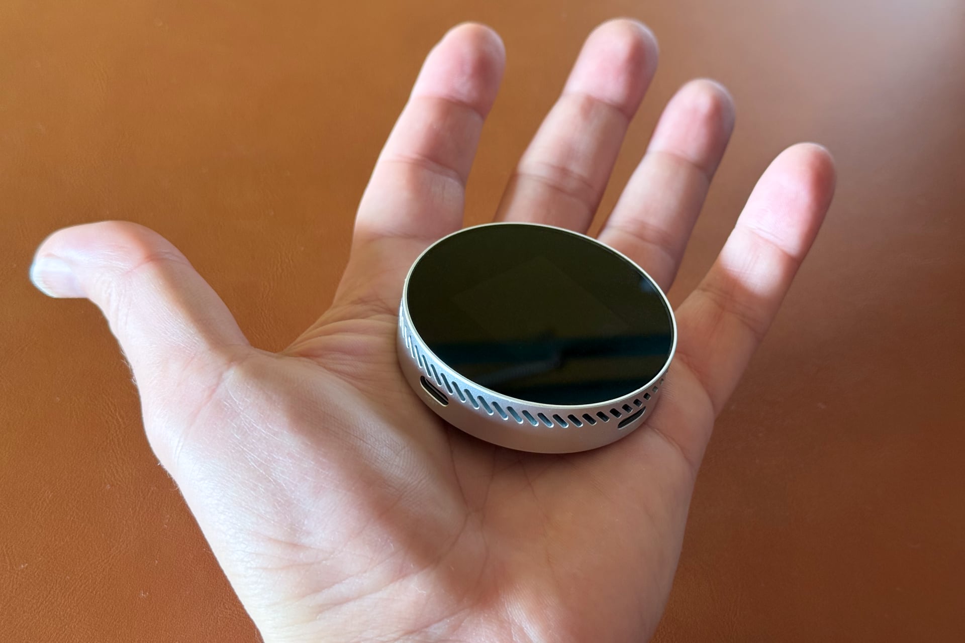 Dockcase MagSafe SSD enclosure in a palm of a male hand.