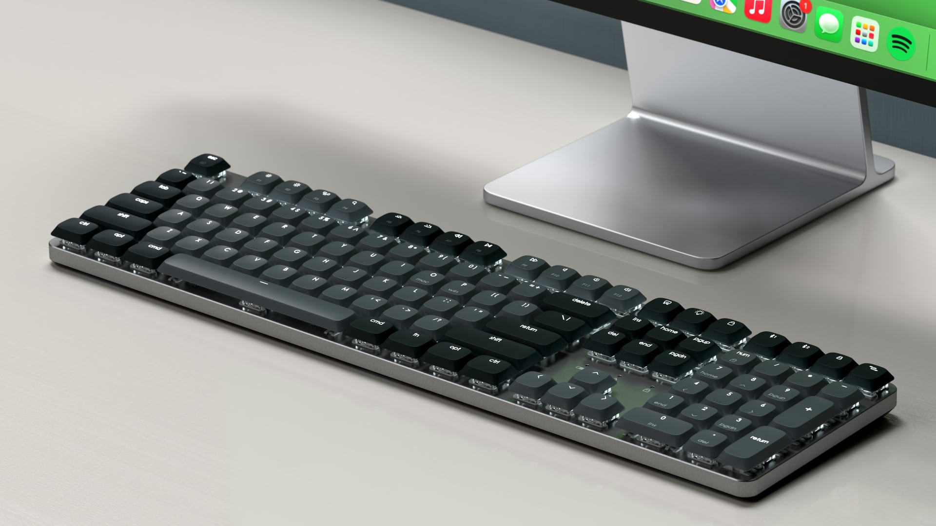 Satechi's mechanical keyboard next to Apple's Studio Display.