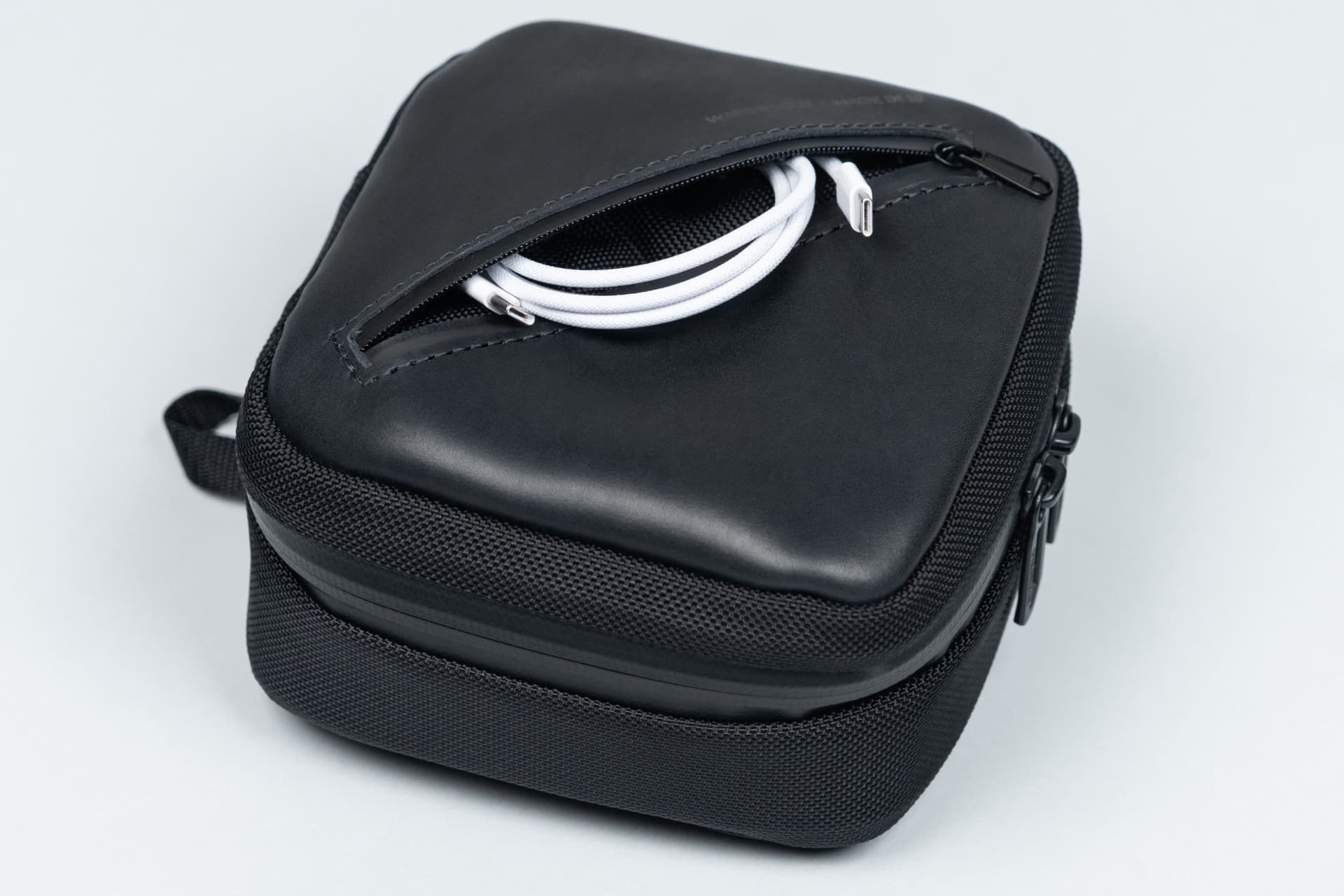 Waterfield's Mac mini case with a USB-C cable in the front pocket.