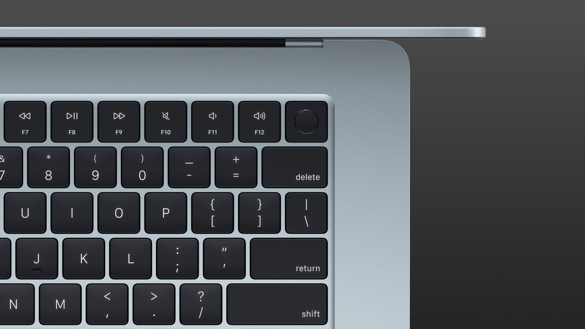 Top down view of a MacBook Air's keyboard focused on a Touch ID button.