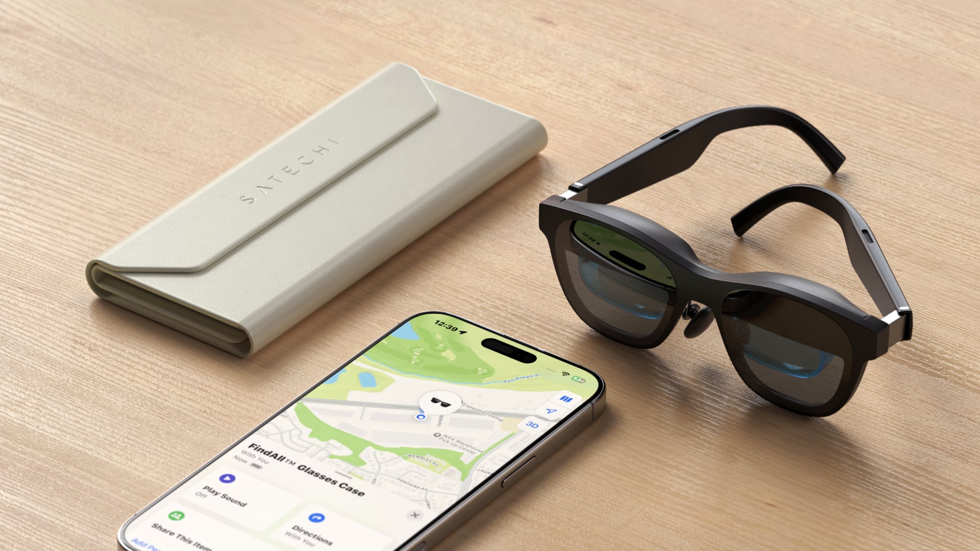 AR glasses, an iPhone and Satechi's glasses case on a wooden desk.