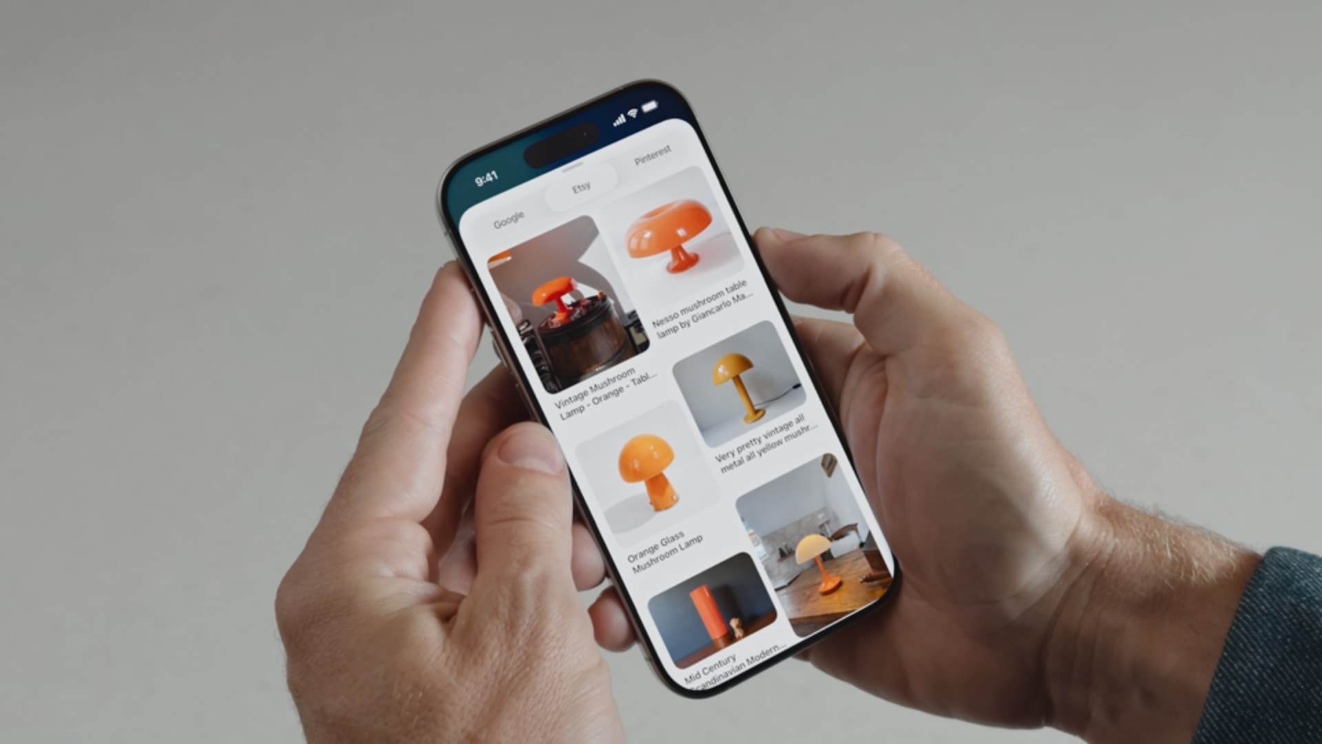iPhone held in hands, showing image search results with visual intelligence.