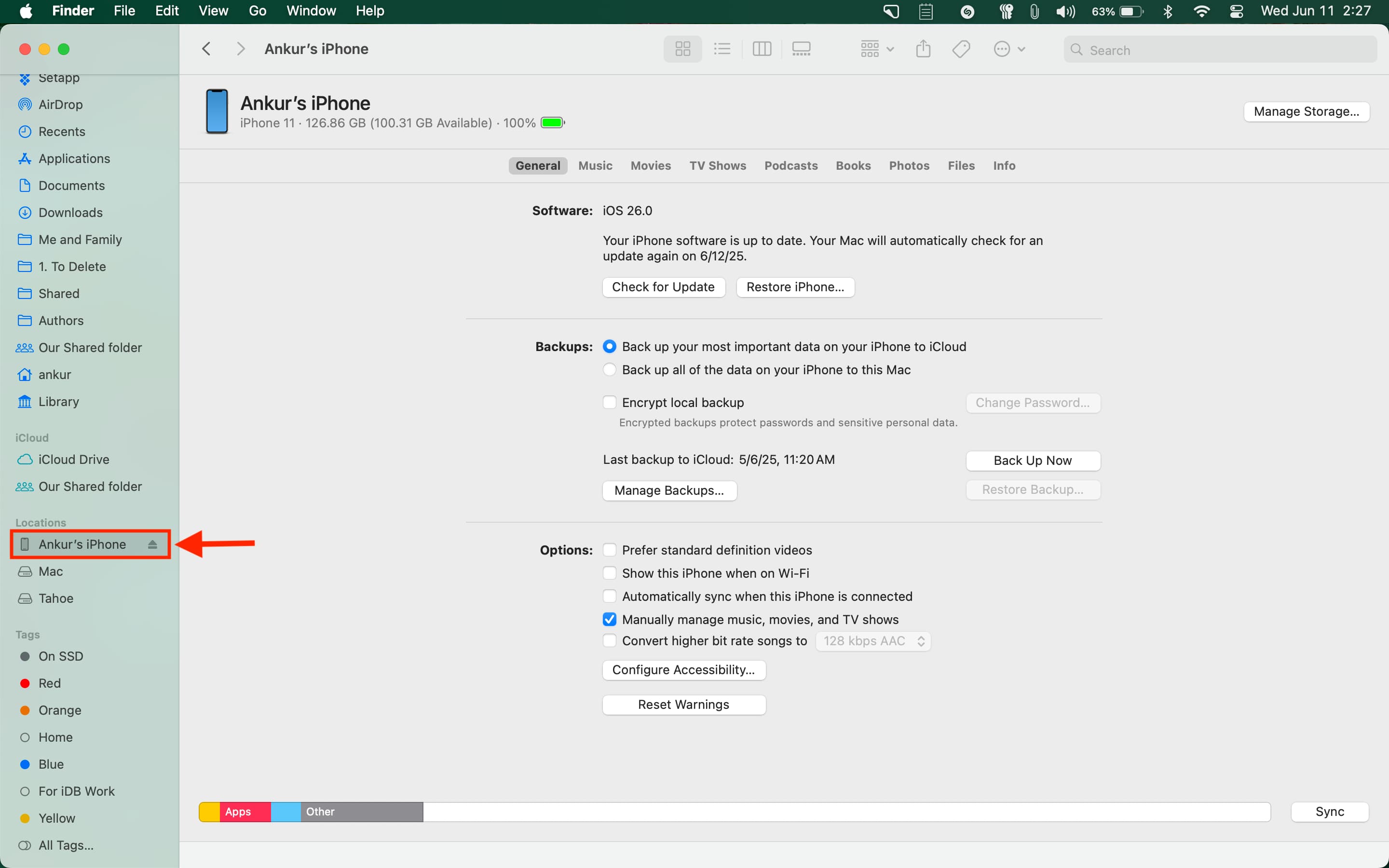 Selecting iPhone running iOS 26 in Finder on Mac